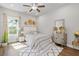Inviting bedroom with a plush bed, decorative accents, and ample natural light from the large window at 704 Chipping Sparrow St, Canton, GA 30115
