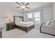 Serene bedroom with a dark wood bed frame, neutral decor, and ample natural light at 704 Chipping Sparrow St, Canton, GA 30115