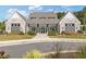 A beautiful white brick clubhouse with black trim and lush landscaping at 704 Chipping Sparrow St, Canton, GA 30115