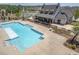 A large pool with a concrete deck and covered patio area at 704 Chipping Sparrow St, Canton, GA 30115