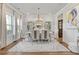 Chic dining room with modern decor, featuring a stylish chandelier and plush white rug at 704 Chipping Sparrow St, Canton, GA 30115