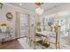 Bright dining room with modern light fixture, windows with custom draperies and seating for six at 704 Chipping Sparrow St, Canton, GA 30115
