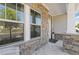 Charming front porch with stone columns, decorative tile, and a welcoming entrance at 704 Chipping Sparrow St, Canton, GA 30115
