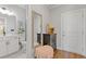 Hallway with pretty mirror and stool and door leading to a bathroom at 704 Chipping Sparrow St, Canton, GA 30115