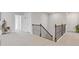 Upper hallway featuring wrought iron railing and access to bedrooms at 704 Chipping Sparrow St, Canton, GA 30115