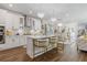 Bright kitchen with white cabinets, stainless steel appliances, quartz countertops and elegant lighting fixtures at 704 Chipping Sparrow St, Canton, GA 30115