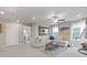 Spacious living area with a plush sectional, stylish decor, and ample natural light from the windows at 704 Chipping Sparrow St, Canton, GA 30115