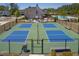 Overhead shot of community pickleball courts, fenced in and surrounded by benches and landscaping at 704 Chipping Sparrow St, Canton, GA 30115
