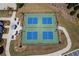 Overhead shot of community pickleball courts is lit by lampposts and surrounded by walking paths at 704 Chipping Sparrow St, Canton, GA 30115