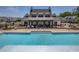 A large community pool has a zero entry point with stairs and a view of the clubhouse at 704 Chipping Sparrow St, Canton, GA 30115