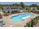 Aerial view of the community pool and clubhouse, surrounded by lounge chairs and well-manicured landscaping at 704 Chipping Sparrow St, Canton, GA 30115