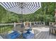 Outdoor seating area on the back deck with a dining table and patio furniture at 125 Fortuna Ct, Roswell, GA 30075