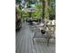 Large back deck with views of a wooded backyard area with patio seating at 125 Fortuna Ct, Roswell, GA 30075