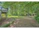 Expansive backyard featuring a gazebo, mature trees, and a landscaped garden at 125 Fortuna Ct, Roswell, GA 30075