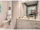 Clean bathroom featuring a toilet, vanity, mirror, and decorative accents at 125 Fortuna Ct, Roswell, GA 30075