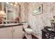 Decorated bathroom featuring a toilet, sink and vanity at 125 Fortuna Ct, Roswell, GA 30075