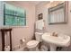 Bright bathroom featuring a window, toilet, sink and vanity at 125 Fortuna Ct, Roswell, GA 30075