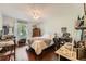 Comfortable bedroom with a bed, natural light, and hardwood floors at 125 Fortuna Ct, Roswell, GA 30075