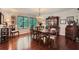 Formal dining room with hardwood floors, a chandelier, and a large window overlooking the greenery at 125 Fortuna Ct, Roswell, GA 30075
