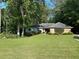 Charming home with a well-manicured front yard, mature trees, and stone accents, creating a welcoming curb appeal at 125 Fortuna Ct, Roswell, GA 30075