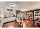 Traditional kitchen with white cabinets, black countertops, a central island, and a dining area at 125 Fortuna Ct, Roswell, GA 30075