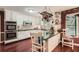 Bright kitchen equipped with white cabinets, stainless steel oven, and an island with additional seating at 125 Fortuna Ct, Roswell, GA 30075