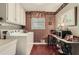 Functional laundry room with a washer, dryer, utility sink, and vintage accents at 125 Fortuna Ct, Roswell, GA 30075
