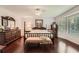 Spacious main bedroom with a wooden dresser and ample natural light at 125 Fortuna Ct, Roswell, GA 30075