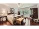 Serene main bedroom with hardwood floors, a four-poster bed, and bright natural light at 125 Fortuna Ct, Roswell, GA 30075