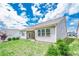 Green backyard with patio and ample natural light shining on the home's exterior at 213 Hickory Bluffs Pkwy, Canton, GA 30114