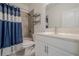 Cozy bathroom features tiled shower and tub, patterned shower curtain, and white vanity at 213 Hickory Bluffs Pkwy, Canton, GA 30114