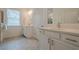 Clean bathroom features a dual sink vanity with modern fixtures, tile flooring and lots of light at 213 Hickory Bluffs Pkwy, Canton, GA 30114
