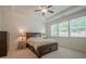 Comfortable bedroom features a tray ceiling, natural light from the windows and neutral carpet at 213 Hickory Bluffs Pkwy, Canton, GA 30114