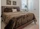 Comfortable bedroom features a plush bed, dark furniture and a window for natural light at 213 Hickory Bluffs Pkwy, Canton, GA 30114