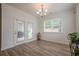 Bright dining area features wood floors, ample natural light from the windows and access to outdoor patio at 213 Hickory Bluffs Pkwy, Canton, GA 30114