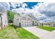 View of home with a two-car garage, long driveway, and well-maintained lawn and landscaping at 213 Hickory Bluffs Pkwy, Canton, GA 30114