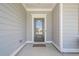 Elegant front door with glass panel, framed by gray siding and white trim at 213 Hickory Bluffs Pkwy, Canton, GA 30114