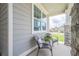 Inviting front porch with seating area and stone pillars, providing a cozy outdoor space at 213 Hickory Bluffs Pkwy, Canton, GA 30114