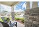Charming front porch with stone supports, outdoor seating, and views of the neighborhood at 213 Hickory Bluffs Pkwy, Canton, GA 30114