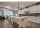 Modern kitchen with white cabinets, a large island, and stainless steel appliances, open to the living area at 213 Hickory Bluffs Pkwy, Canton, GA 30114