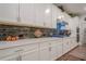 Kitchen showcasing white cabinetry, modern hardware, a stainless steel hood, and a sleek backsplash at 213 Hickory Bluffs Pkwy, Canton, GA 30114