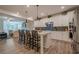 Open kitchen area shows a large island, stainless steel appliances, and an adjacent living area at 213 Hickory Bluffs Pkwy, Canton, GA 30114