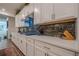 Modern kitchen boasts white cabinetry, stainless steel appliances, and a stylish backsplash at 213 Hickory Bluffs Pkwy, Canton, GA 30114