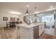 Open kitchen with an island that features a stainless steel dishwasher and a white countertop at 213 Hickory Bluffs Pkwy, Canton, GA 30114