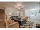 Inviting living room features hardwood floors, a ceiling fan, and plenty of natural light from the large windows at 213 Hickory Bluffs Pkwy, Canton, GA 30114