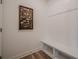 Bright mudroom features a built-in bench, coat hooks, and eye-catching decorative wall art at 213 Hickory Bluffs Pkwy, Canton, GA 30114