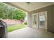 Covered patio features exterior access door and lush backyard at 213 Hickory Bluffs Pkwy, Canton, GA 30114