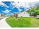 Well-maintained lawn surrounds the home, with mature trees in the background, and sidewalks at 213 Hickory Bluffs Pkwy, Canton, GA 30114