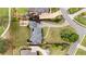 An aerial view of a private estate with lush greenery, featuring a circular driveway and meticulously landscaped grounds at 2211 Lattimore Farm Nw Dr, Kennesaw, GA 30152