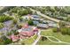 An aerial view displays a community pool, tennis courts, and clubhouse with putting greens surrounded by mature trees at 2211 Lattimore Farm Nw Dr, Kennesaw, GA 30152